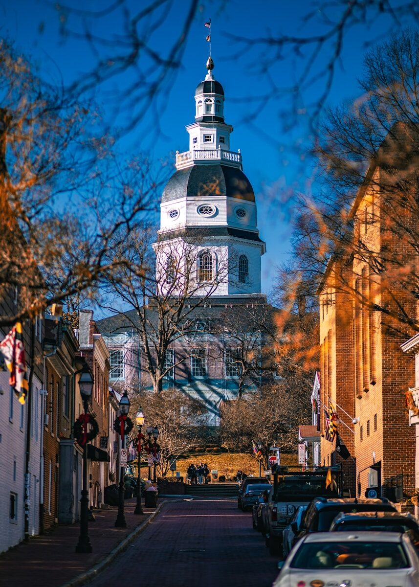 Photo by Nils Huenerfuerst a large clock tower towering over a city street
